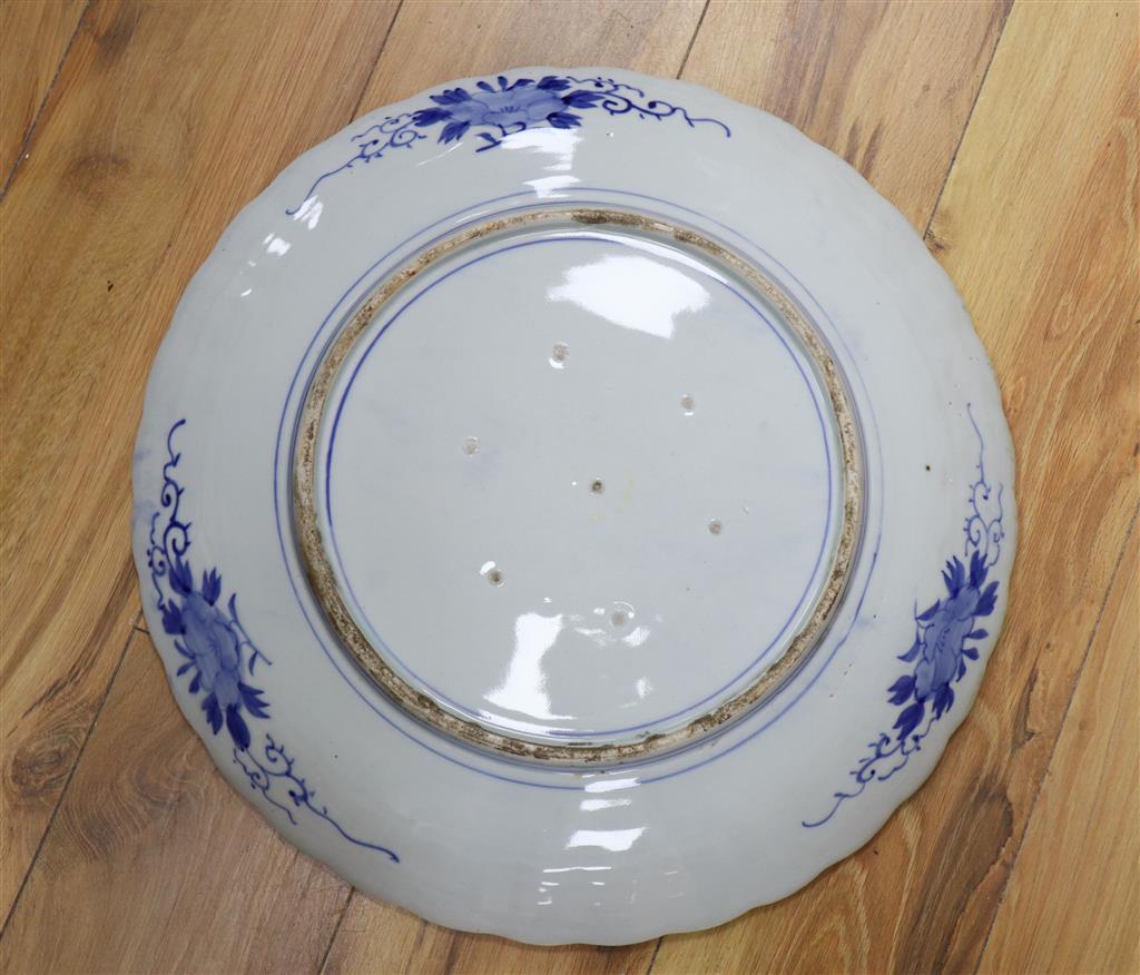 A Japanese blue and white charger decorated with a flying bird and chrysanthemum flowers, 48cm diameter Dia 47.5cm